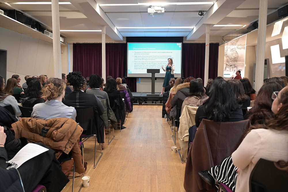 Emily Miles, executive director of The Alliance Against Sexual Violence speaking at a conference